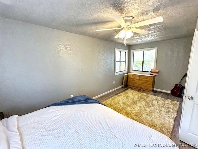 19690 W 892nd Rd, Park Hill, OK 74451 - bedroom featuring a ceiling fan, a textured ceiling, and a textured wall