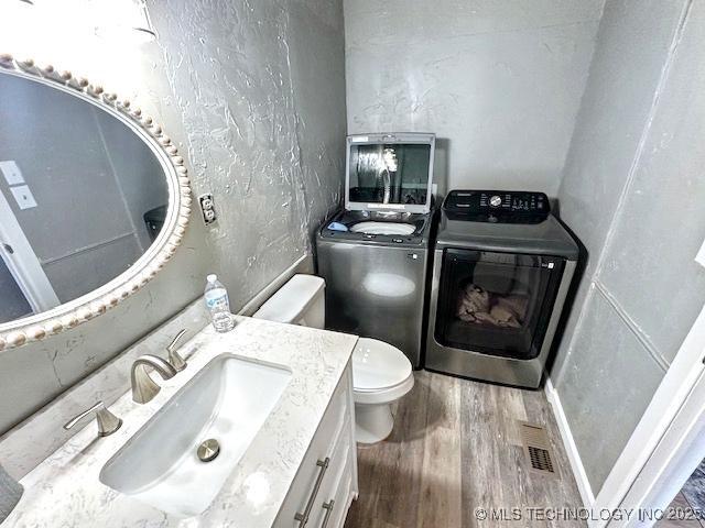 19690 W 892nd Rd, Park Hill, OK 74451 - bathroom featuring washer / clothes dryer, wood finished floors, vanity, and a textured wall