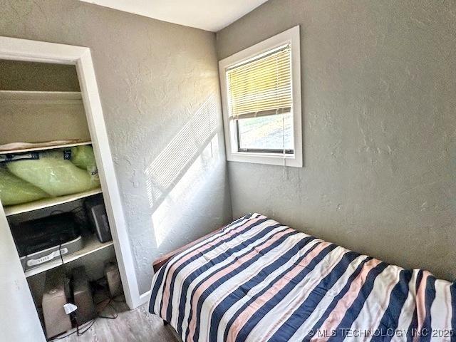 19690 W 892nd Rd, Park Hill, OK 74451 - bedroom featuring a textured wall and wood finished floors