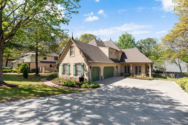 view of front of property featuring driveway, stone siding, stucco siding, a front lawn, and a garage