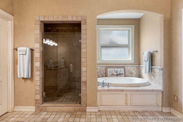 bathroom with a garden tub and a stall shower