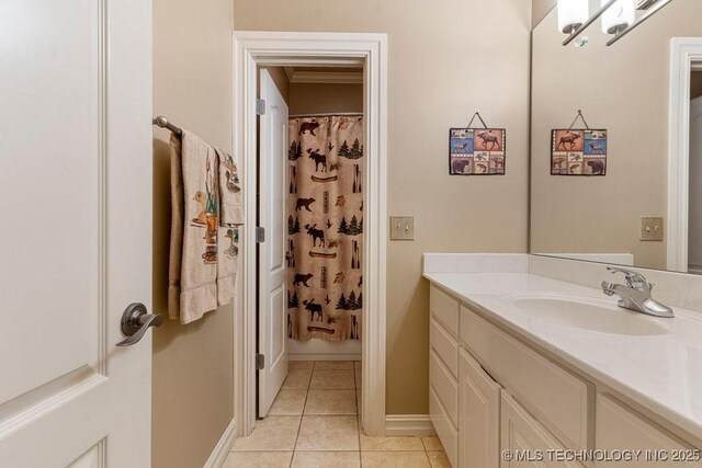 bathroom featuring baseboards, tile patterned flooring, and vanity