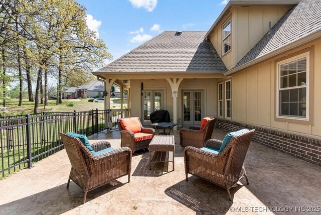 view of patio featuring an outdoor living space, fence, and french doors