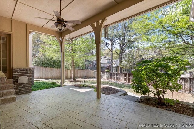 view of patio with a fenced backyard and a ceiling fan