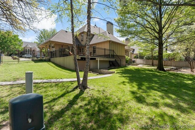 view of yard featuring stairs, a wooden deck, and a fenced backyard