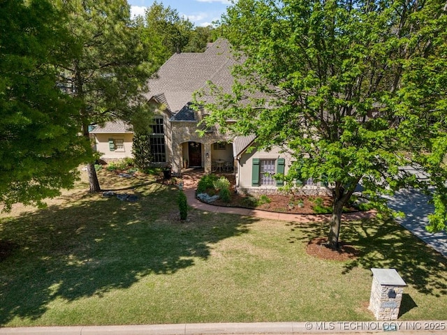 view of front of property with a front lawn and stone siding