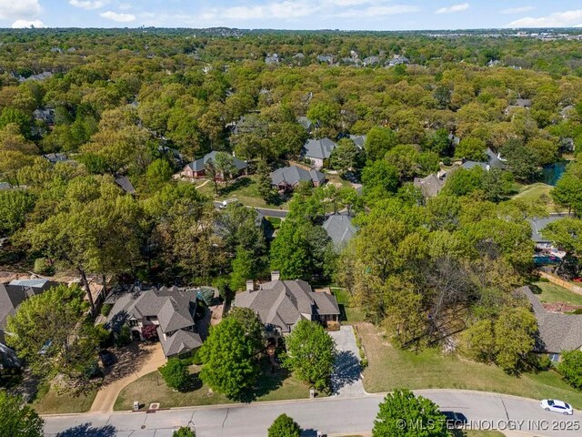 aerial view featuring a wooded view and a residential view