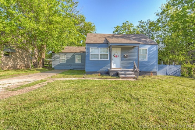 bungalow featuring driveway, crawl space, and a front yard