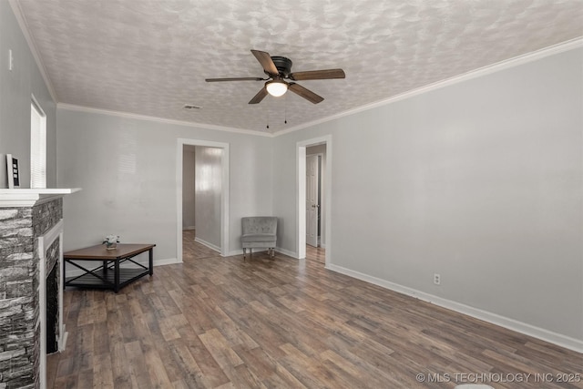 unfurnished living room featuring visible vents, baseboards, a ceiling fan, wood finished floors, and a fireplace