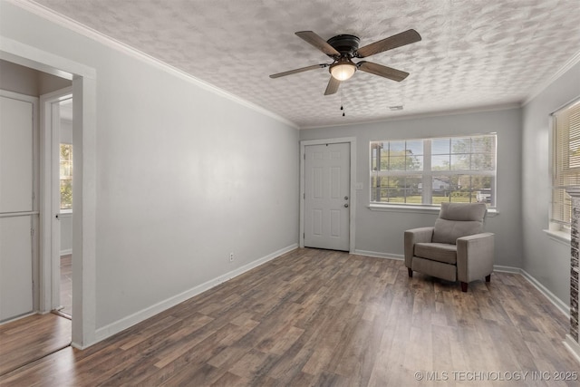 sitting room with baseboards, wood finished floors, and ceiling fan