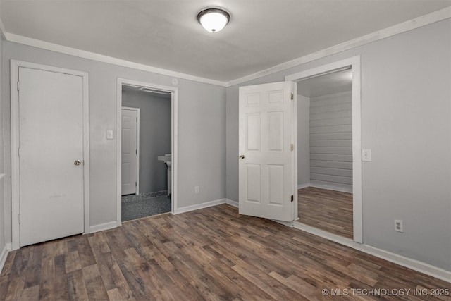 unfurnished bedroom with dark wood-type flooring and baseboards