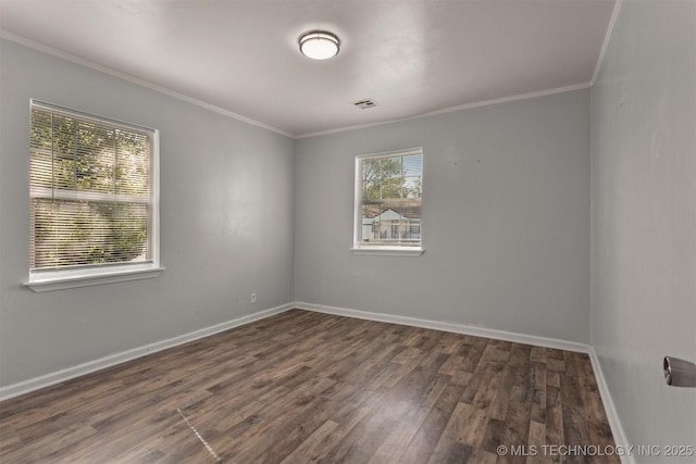 unfurnished room featuring visible vents, baseboards, wood finished floors, and crown molding