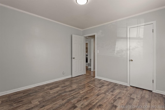unfurnished bedroom featuring baseboards, crown molding, and wood finished floors