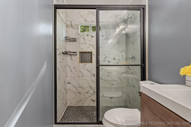 bathroom featuring toilet, vanity, and a marble finish shower