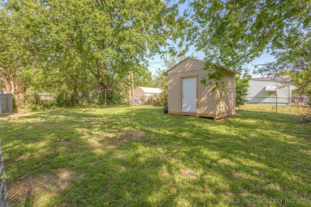 view of yard with a fenced backyard, an outdoor structure, and a shed