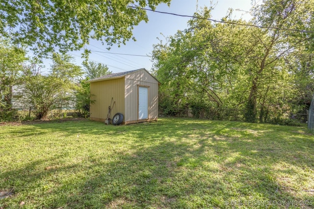 view of yard featuring a fenced backyard, an outbuilding, and a shed