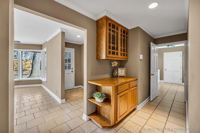 hallway with recessed lighting, baseboards, ornamental molding, and light tile patterned floors