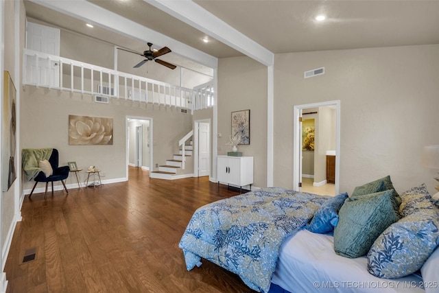 bedroom with high vaulted ceiling, beamed ceiling, wood finished floors, and visible vents