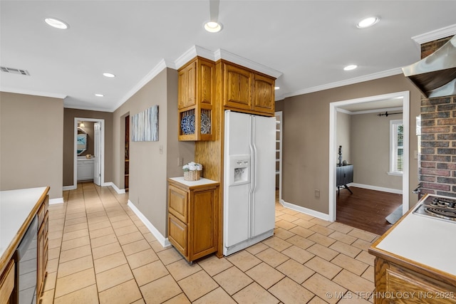 kitchen with recessed lighting, visible vents, crown molding, baseboards, and white fridge with ice dispenser