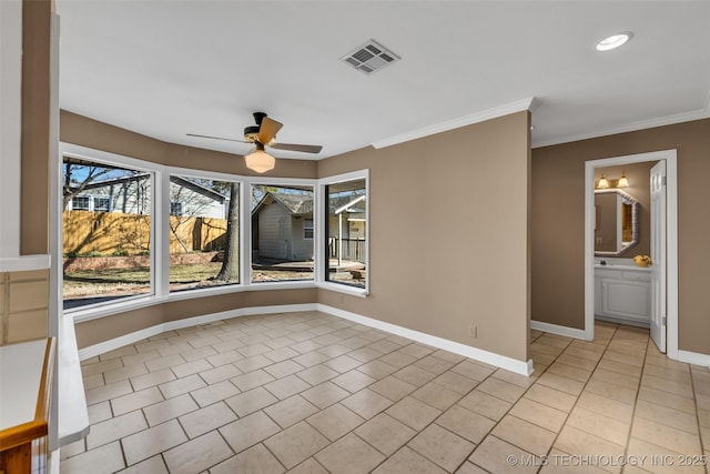 spare room featuring crown molding, visible vents, a ceiling fan, and baseboards