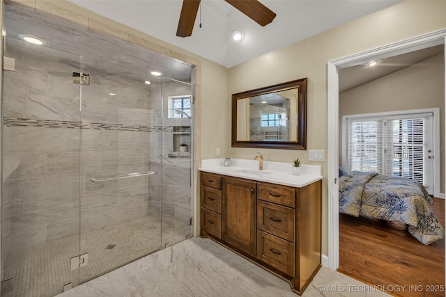 full bathroom with a ceiling fan, a stall shower, vanity, ensuite bath, and lofted ceiling