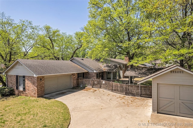 view of front facade featuring an attached garage, a shingled roof, brick siding, and concrete driveway