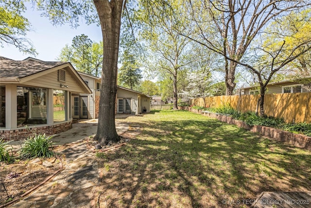 view of yard featuring french doors and fence private yard