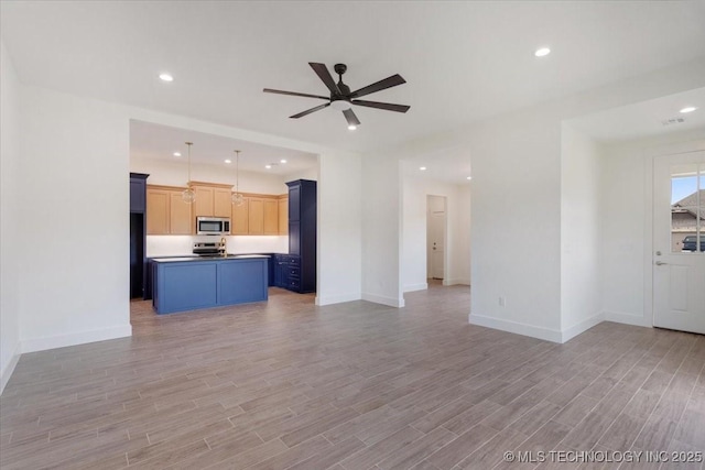 unfurnished living room with recessed lighting, baseboards, a ceiling fan, and light wood-type flooring