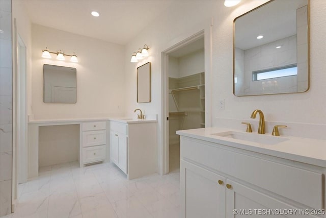 full bathroom featuring two vanities, a sink, a spacious closet, recessed lighting, and marble finish floor