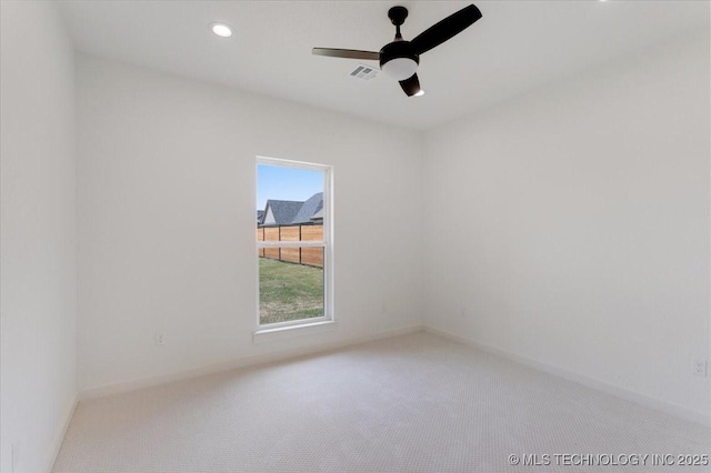 unfurnished room with ceiling fan, baseboards, carpet flooring, and visible vents