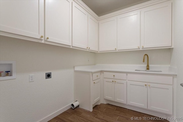 laundry room with a sink, hookup for an electric dryer, dark wood finished floors, washer hookup, and cabinet space