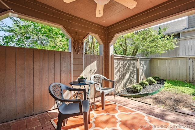 view of patio with a fenced backyard and ceiling fan