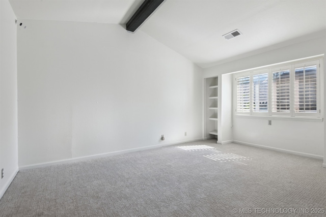 unfurnished room with baseboards, vaulted ceiling with beams, and carpet