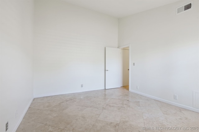 empty room with baseboards and visible vents