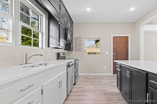 401 S Brewer St, Vinita, OK 74301 - kitchen with recessed lighting, stainless steel appliances, light countertops, a sink, and light wood-style floors