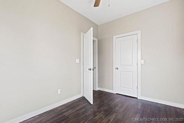 401 S Brewer St, Vinita, OK 74301 - unfurnished room with ceiling fan, baseboards, and dark wood-style flooring