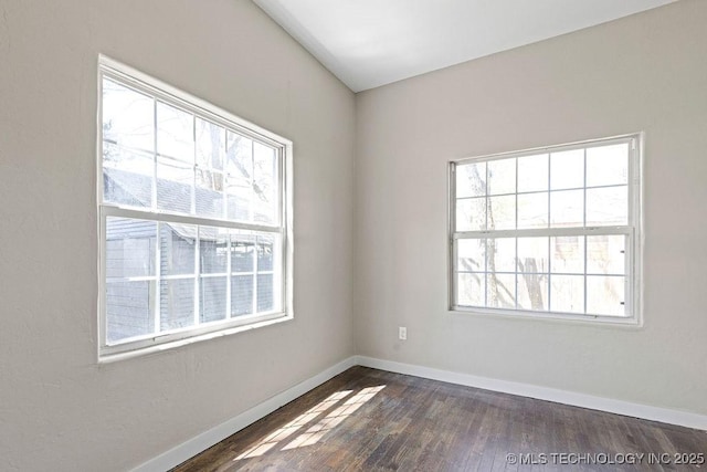 401 S Brewer St, Vinita, OK 74301 - spare room featuring baseboards and dark wood-style floors