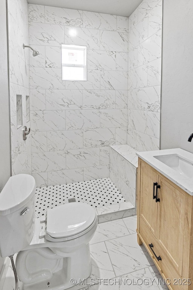 401 S Brewer St, Vinita, OK 74301 - full bathroom with vanity, marble finish floor, a stall shower, and toilet