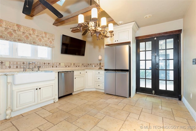 kitchen featuring a sink, a chandelier, a wealth of natural light, french doors, and stainless steel appliances