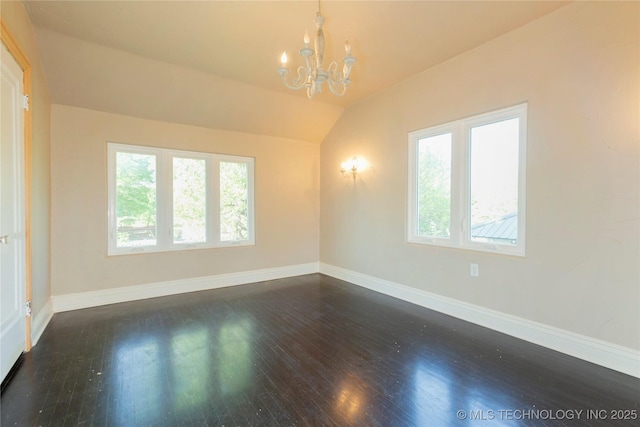 spare room with a healthy amount of sunlight, baseboards, and a notable chandelier
