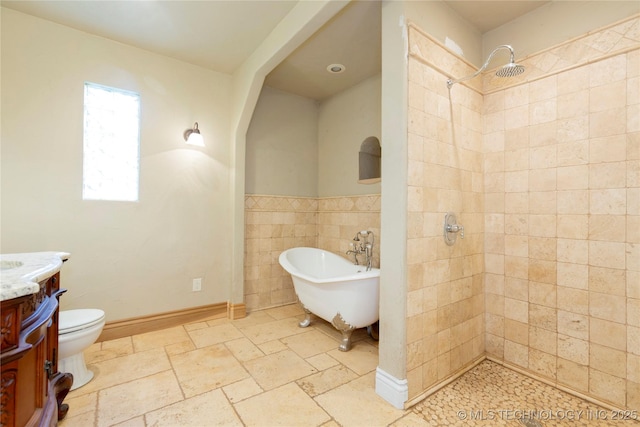 full bathroom with a soaking tub, toilet, tile walls, tiled shower, and vanity