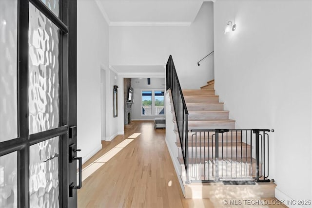 12754 S Irvington Ave, Tulsa, OK 74137 - foyer with a towering ceiling, wood finished floors, crown molding, baseboards, and stairs