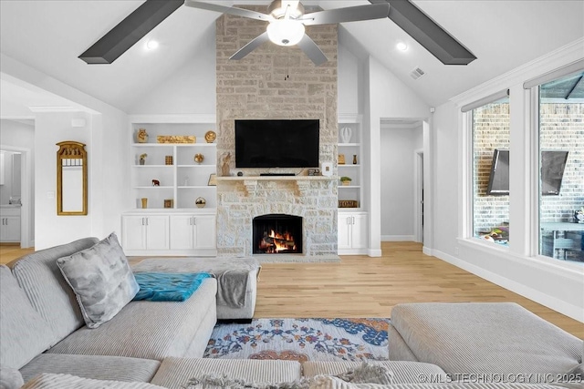 12754 S Irvington Ave, Tulsa, OK 74137 - living area with visible vents, a ceiling fan, a stone fireplace, and wood finished floors