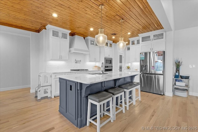 12754 S Irvington Ave, Tulsa, OK 74137 - kitchen with white cabinets, wooden ceiling, a sink, premium range hood, and appliances with stainless steel finishes