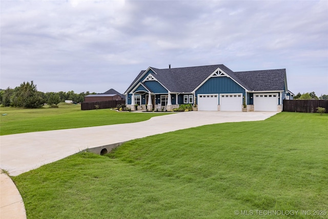 view of front of house with a garage, concrete driveway, board and batten siding, fence, and a front yard