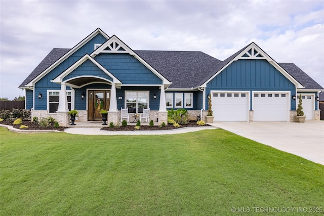 craftsman-style home featuring concrete driveway, board and batten siding, stone siding, a front yard, and a garage
