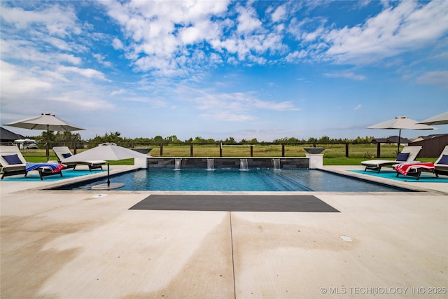 pool featuring fence and a patio area