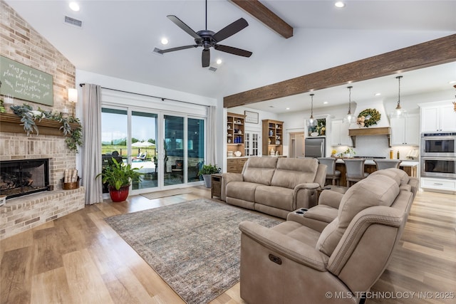 living room with recessed lighting, visible vents, vaulted ceiling with beams, a ceiling fan, and a brick fireplace