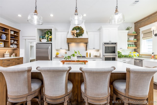 kitchen with white cabinets, stainless steel appliances, open shelves, light countertops, and visible vents