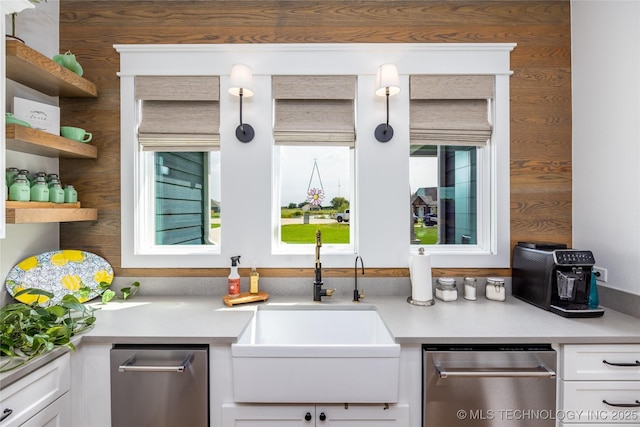 bar with a healthy amount of sunlight, stainless steel dishwasher, and a sink